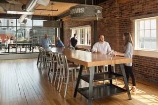 Union Stables Kitchen area with recycled wood, bricks and fans