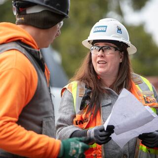 Male and female construction staff reviewing the plan