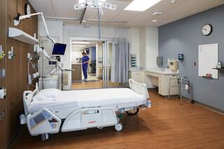 Hospital room with nurse in the background