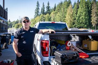 Aaron Stegmeier stands beside his new hybrid F-150 Lewis truck
