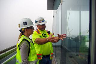 Mentor and mentee talking about the glass installation