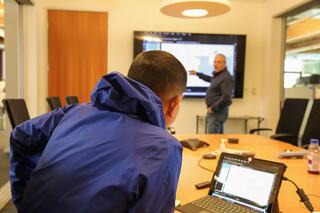 Mentor and mentee discussing over a floor plan