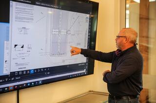 Mentor and mentee discussing over a floor plan