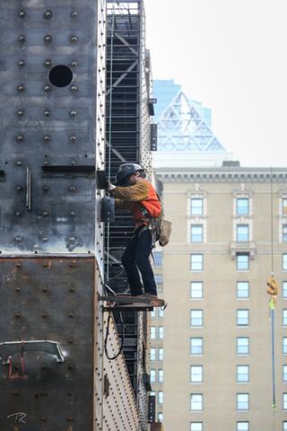 Jobsite crew climbing up on the steel structure