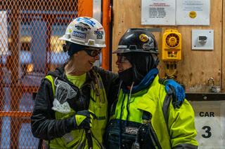 Two women construction workers talking at the construction site