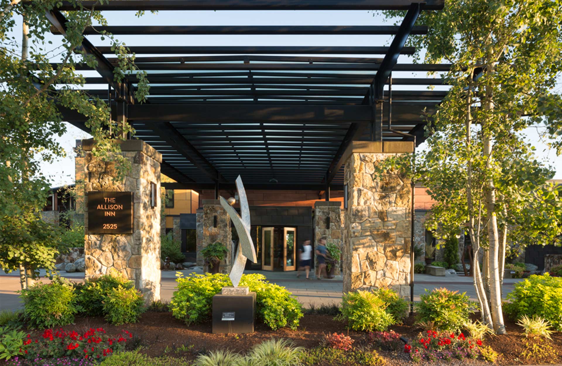 The Allison Inn and Spa entrance with trees and flowers